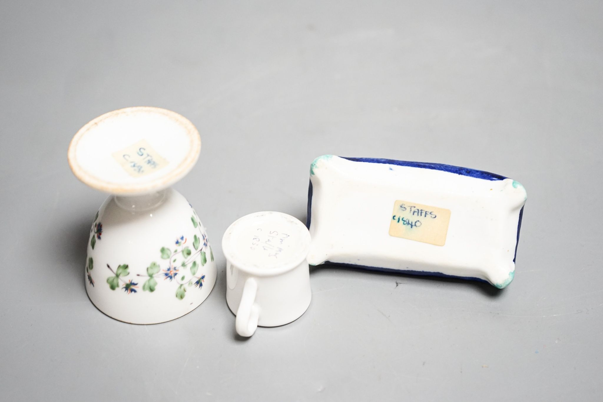 A mid 19th century Staffordshire porcelain Dalmatian pen holder and a cornflower spray egg cup and a miniature mug, tallest 6cm